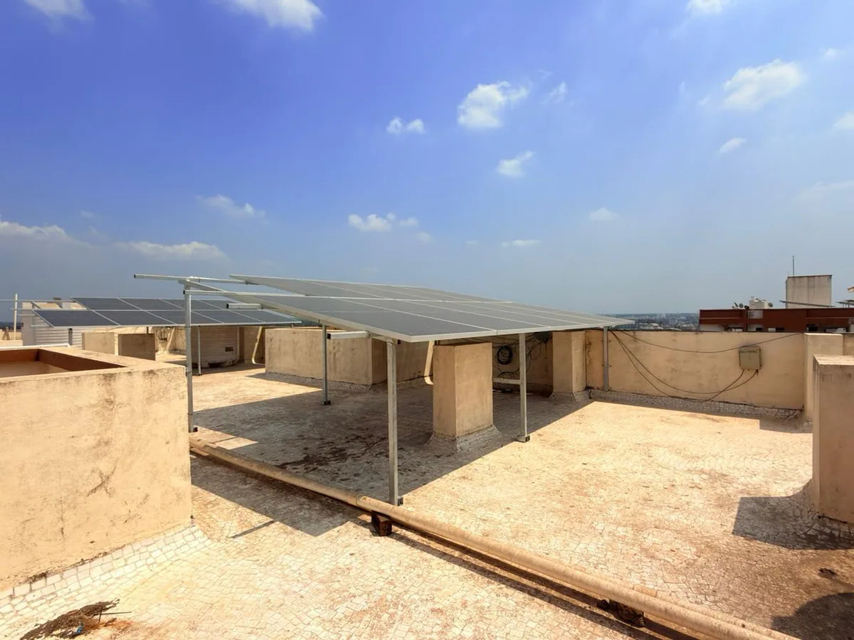 Completed elevated rooftop solar panel array under a clear sky