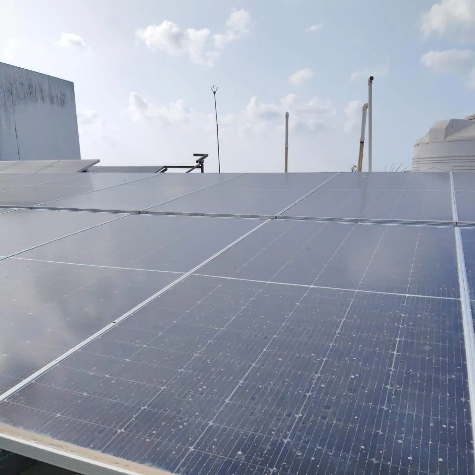 Close view of installed photovoltaic modules during a rooftop performance inspection